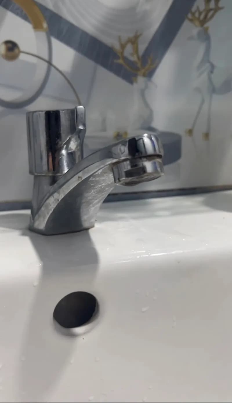 Trước khi sửa: Vòi lavabo bị rỉ nước ngay chỗ chân tại Bình Tân