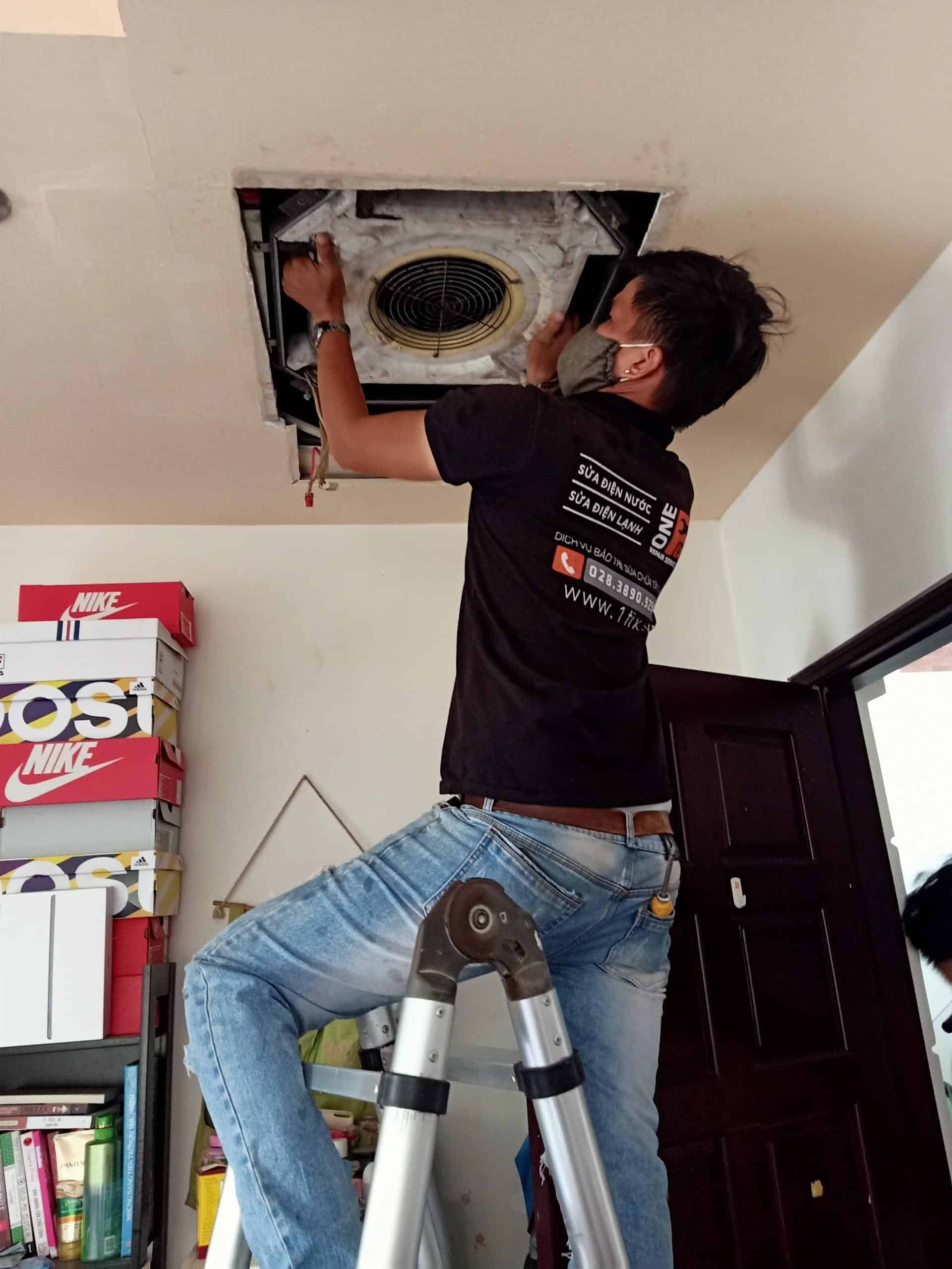 Thợ 1Fix đang dùng máy xịt áp lực cao vệ sinh dàn nóng máy lạnh tại một nhà dân ở quận 10
